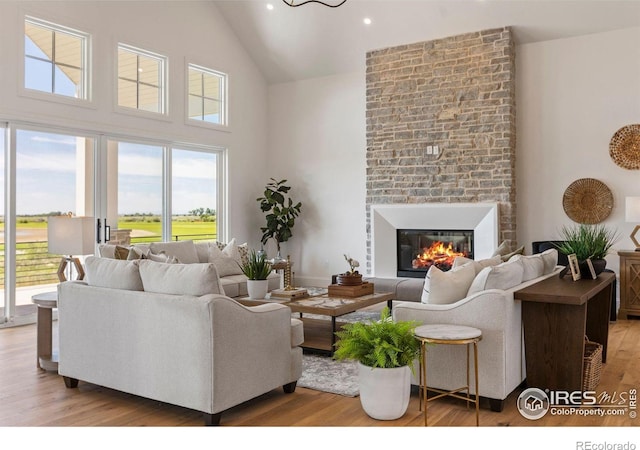2568 Southwind Rd, Berthoud, CO 80513 - living area with high vaulted ceiling, wood finished floors, recessed lighting, and a fireplace