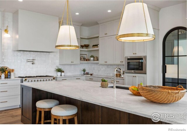 2568 Southwind Rd, Berthoud, CO 80513 - kitchen with stainless steel oven, extractor fan, open shelves, tasteful backsplash, and recessed lighting