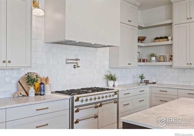 2568 Southwind Rd, Berthoud, CO 80513 - kitchen featuring custom exhaust hood, range with two ovens, open shelves, light countertops, and white cabinets