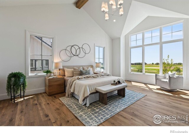 2568 Southwind Rd, Berthoud, CO 80513 - bedroom featuring high vaulted ceiling, a chandelier, wood finished floors, and beamed ceiling