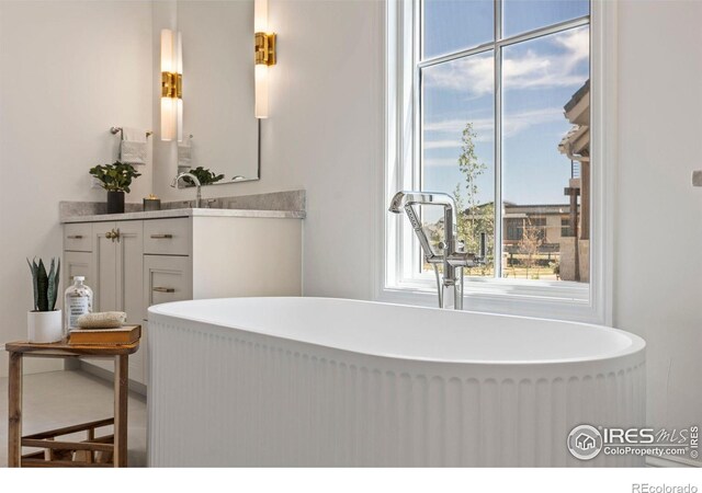 2568 Southwind Rd, Berthoud, CO 80513 - bathroom with vanity, a freestanding tub, and plenty of natural light