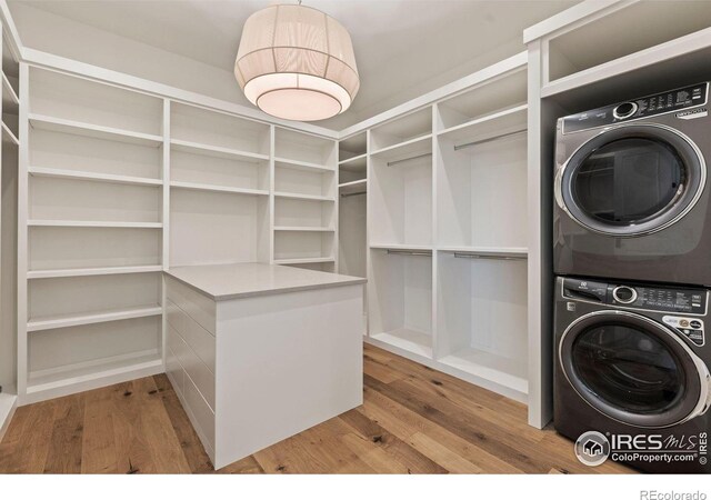2568 Southwind Rd, Berthoud, CO 80513 - walk in closet featuring estacked washer and dryer and wood finished floors