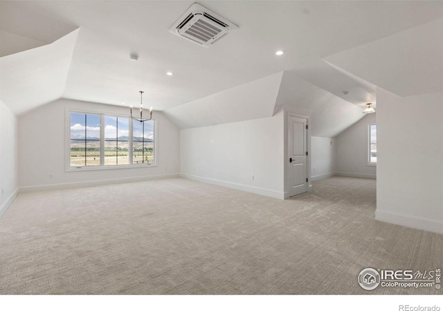 2568 Southwind Rd, Berthoud, CO 80513 - additional living space featuring lofted ceiling, light colored carpet, healthy amount of natural light, recessed lighting, and a chandelier