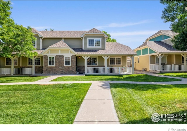 1014 Andrews Peak Dr Unit D112, Fort Collins, CO 80521 - view of front of property featuring a porch, a front lawn, and roof with shingles