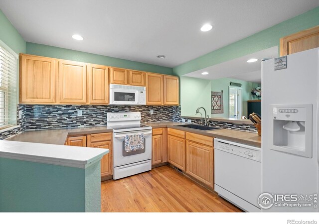 1014 Andrews Peak Dr Unit D112, Fort Collins, CO 80521 - kitchen featuring white appliances, light brown cabinets, light wood finished floors, tasteful backsplash, and recessed lighting