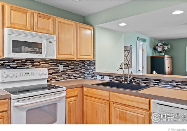 1014 Andrews Peak Dr Unit D112, Fort Collins, CO 80521 - kitchen with white appliances, light brown cabinetry, backsplash, recessed lighting, and light countertops