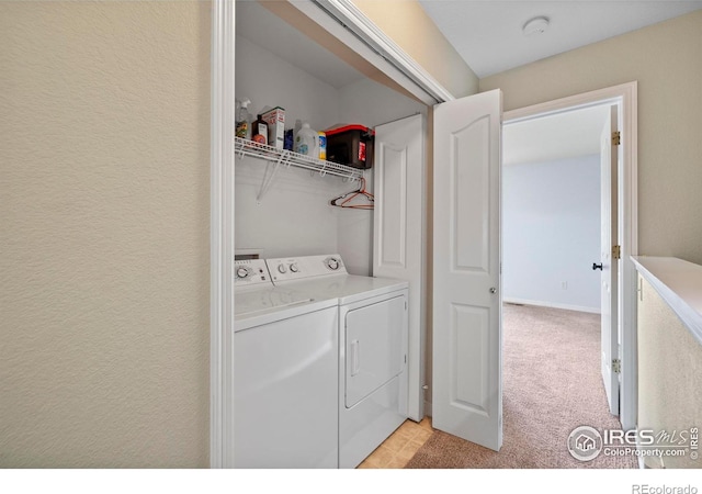 1014 Andrews Peak Dr Unit D112, Fort Collins, CO 80521 - washroom featuring washing machine and clothes dryer and light carpet