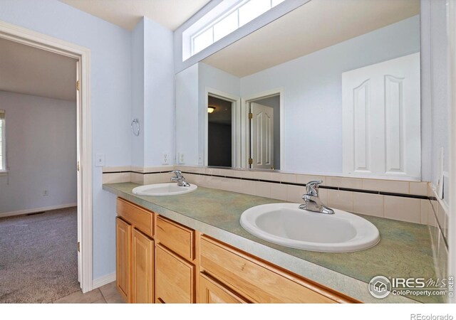 1014 Andrews Peak Dr Unit D112, Fort Collins, CO 80521 - full bathroom featuring double vanity and decorative backsplash