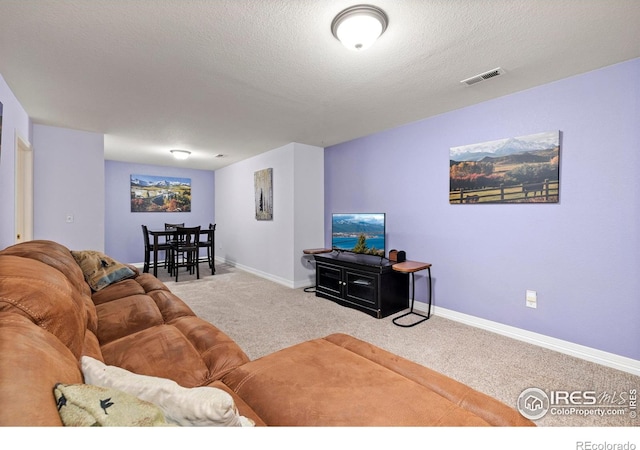 1014 Andrews Peak Dr Unit D112, Fort Collins, CO 80521 - carpeted living room with baseboards and a textured ceiling
