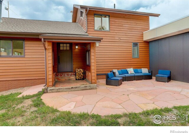 144 Coyote Ct, Boulder, CO 80302 - property entrance featuring a patio, roof with shingles, and an outdoor living space