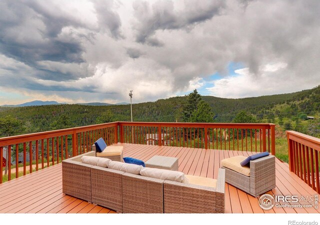144 Coyote Ct, Boulder, CO 80302 - wooden terrace featuring a view of trees and an outdoor living space