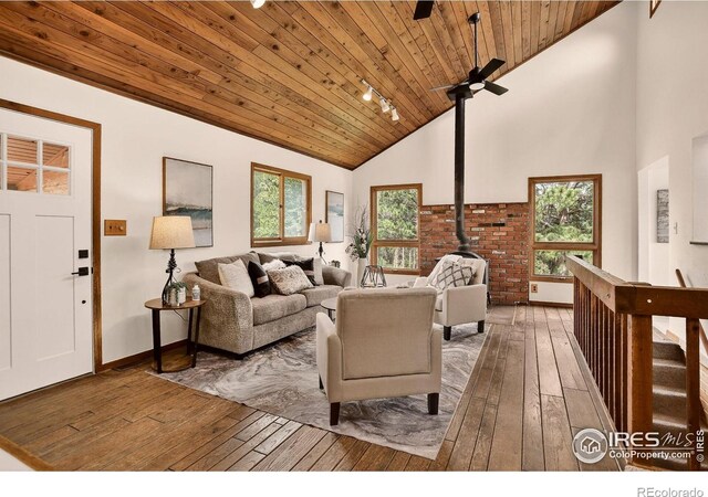 144 Coyote Ct, Boulder, CO 80302 - living area featuring wood-type flooring, wooden ceiling, plenty of natural light, a wood stove, and high vaulted ceiling
