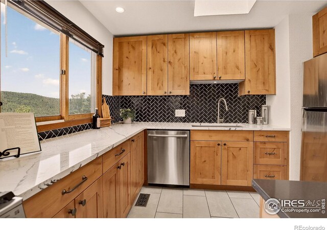 144 Coyote Ct, Boulder, CO 80302 - kitchen with appliances with stainless steel finishes, tasteful backsplash, light tile patterned floors, recessed lighting, and light stone countertops