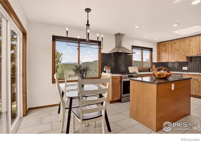 144 Coyote Ct, Boulder, CO 80302 - kitchen with exhaust hood, stainless steel gas range, tasteful backsplash, a center island, and recessed lighting