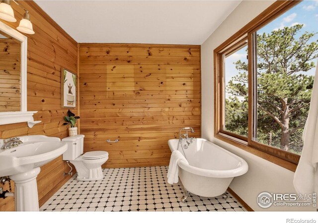 144 Coyote Ct, Boulder, CO 80302 - bathroom featuring a freestanding tub and wood walls