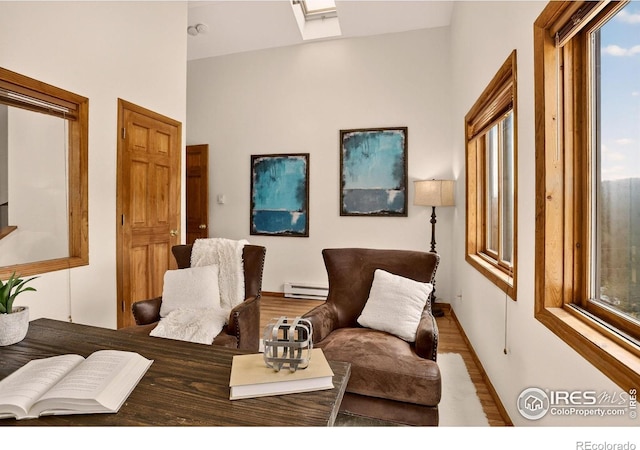 144 Coyote Ct, Boulder, CO 80302 - living area featuring baseboard heating, plenty of natural light, wood finished floors, and a skylight
