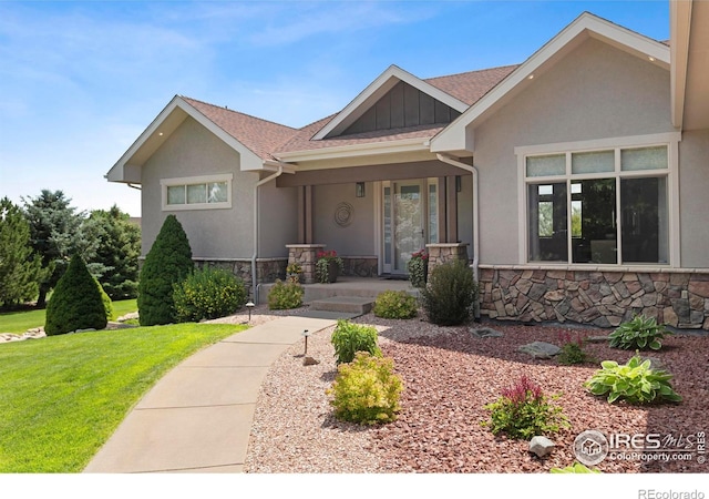 37044 Soaring Eagle Cir, Severance, CO 80550 - view of front of property with stone siding, a front lawn, and stucco siding