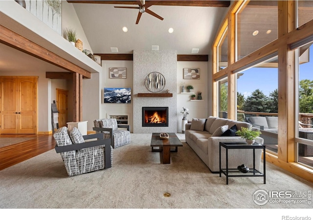 37044 Soaring Eagle Cir, Severance, CO 80550 - living room with a ceiling fan, a large fireplace, high vaulted ceiling, recessed lighting, and wood finished floors