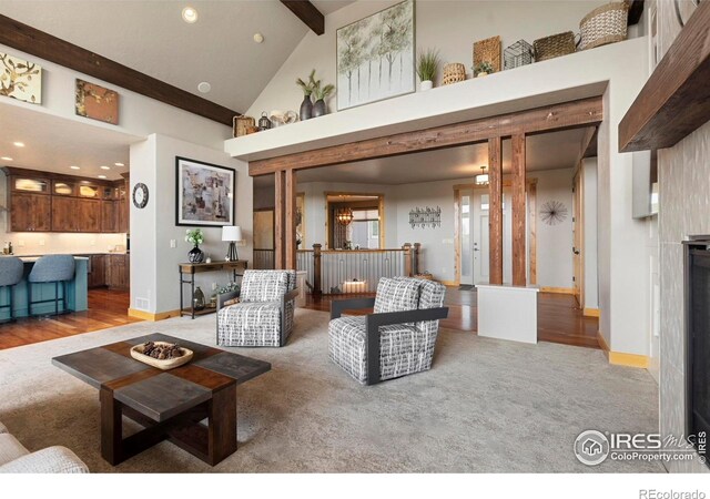 37044 Soaring Eagle Cir, Severance, CO 80550 - living room featuring beam ceiling, recessed lighting, light carpet, light wood-style flooring, and high vaulted ceiling
