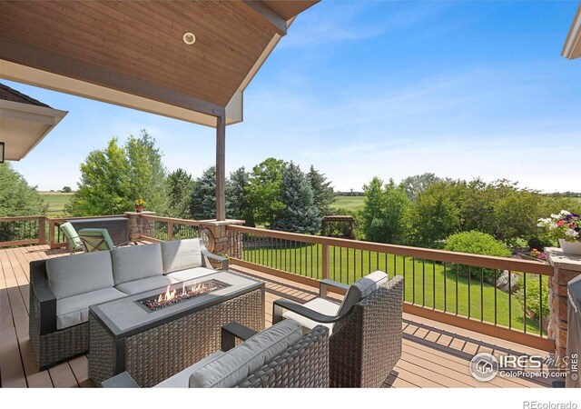 37044 Soaring Eagle Cir, Severance, CO 80550 - wooden deck featuring an outdoor living space with a fire pit and a lawn
