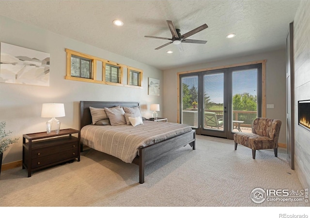 37044 Soaring Eagle Cir, Severance, CO 80550 - bedroom with light carpet, access to exterior, recessed lighting, a fireplace, and a textured ceiling