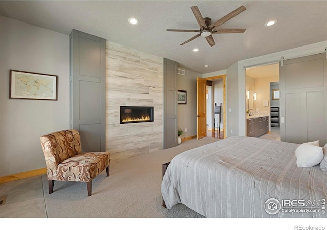 37044 Soaring Eagle Cir, Severance, CO 80550 - bedroom featuring light colored carpet, recessed lighting, a fireplace, connected bathroom, and ceiling fan