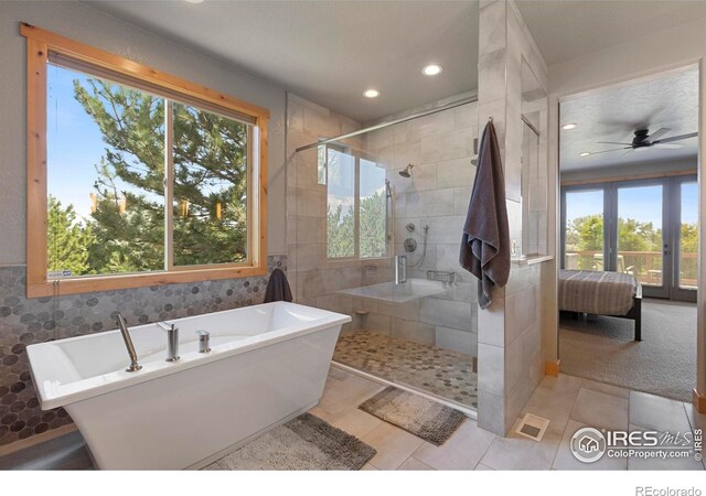 37044 Soaring Eagle Cir, Severance, CO 80550 - ensuite bathroom with plenty of natural light, a freestanding tub, a shower stall, recessed lighting, and tile walls