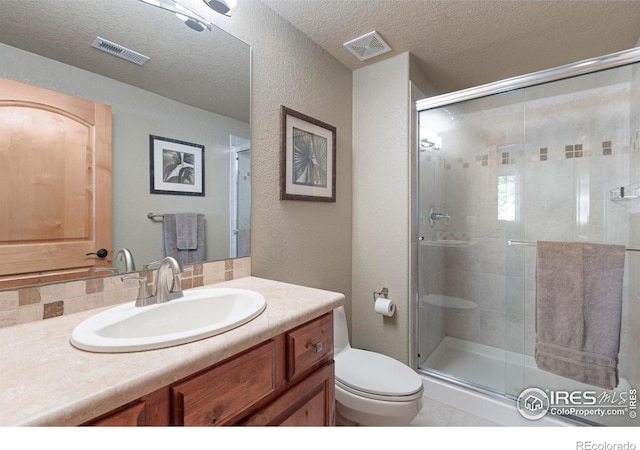 37044 Soaring Eagle Cir, Severance, CO 80550 - full bath with vanity, a shower stall, a textured ceiling, and a textured wall