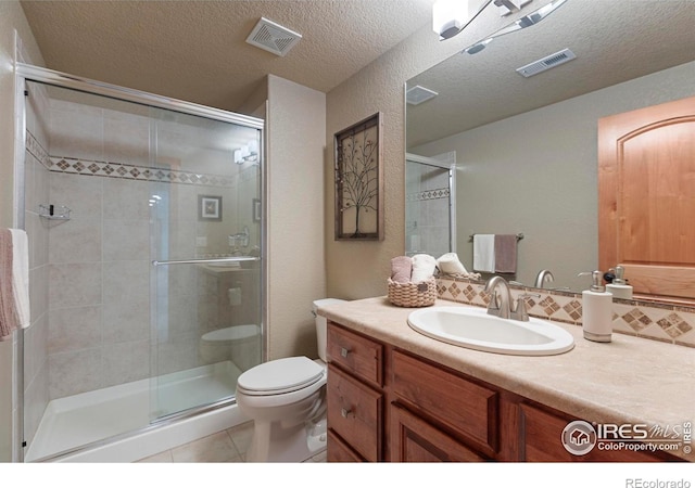 37044 Soaring Eagle Cir, Severance, CO 80550 - bathroom with vanity, tile patterned flooring, a shower stall, backsplash, and a textured ceiling