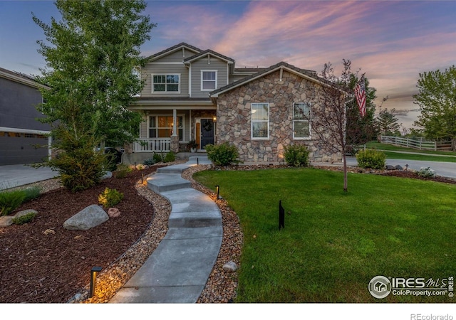 3290 Discovery Ct, Broomfield, CO 80023 - craftsman-style home featuring covered porch, a front lawn, and stone siding