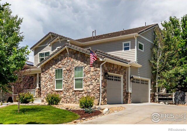3290 Discovery Ct, Broomfield, CO 80023 - craftsman-style home featuring stone siding, concrete driveway, an attached garage, and a front yard