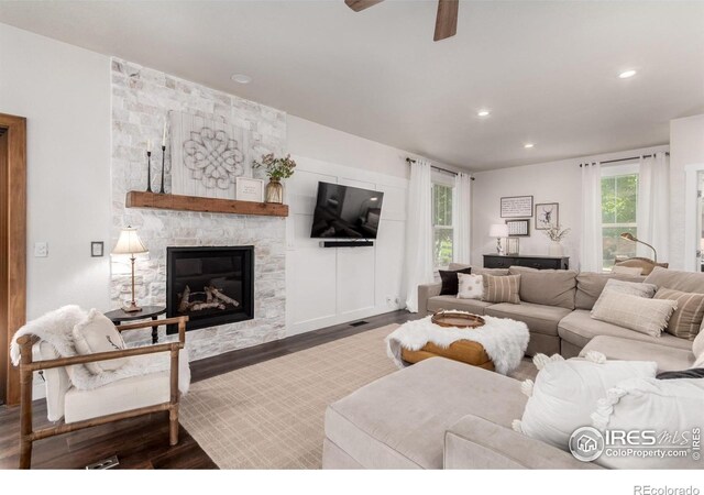 3290 Discovery Ct, Broomfield, CO 80023 - living area featuring a stone fireplace, wood finished floors, recessed lighting, and ceiling fan