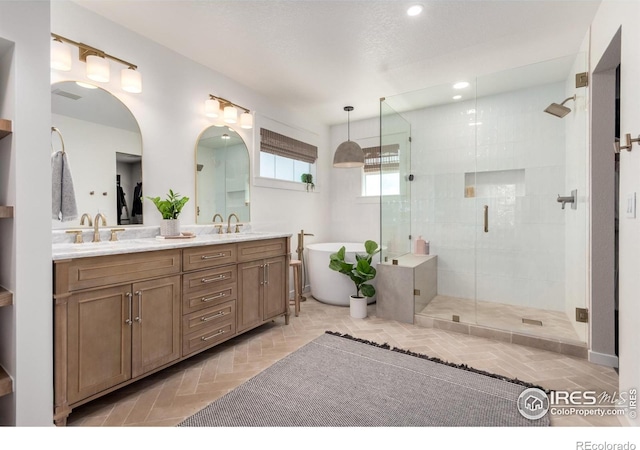 3290 Discovery Ct, Broomfield, CO 80023 - bathroom featuring a stall shower, double vanity, a freestanding bath, and recessed lighting