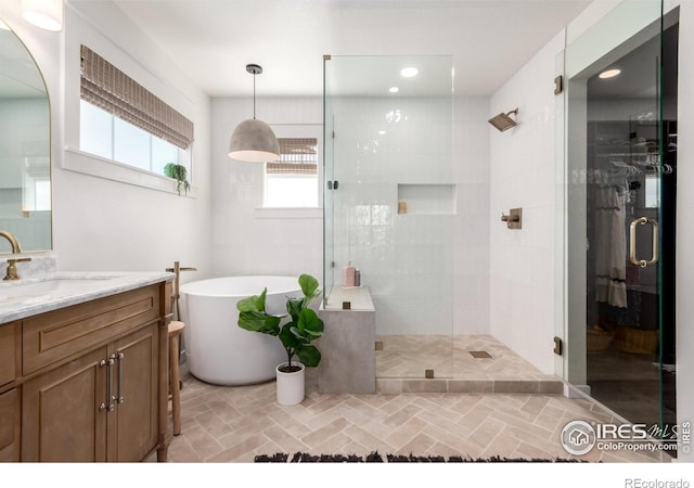 3290 Discovery Ct, Broomfield, CO 80023 - full bathroom featuring vanity, a stall shower, and a freestanding tub