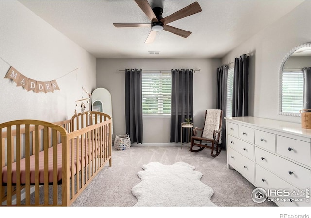 3290 Discovery Ct, Broomfield, CO 80023 - bedroom featuring a nursery area, light colored carpet, and ceiling fan