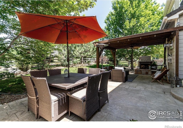 3290 Discovery Ct, Broomfield, CO 80023 - view of patio / terrace with outdoor dining space and an outdoor living space with a fireplace