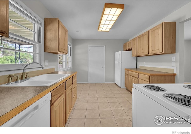2416 15th Ave, Greeley, CO 80631 - kitchen with white appliances, light tile patterned floors, light brown cabinetry, and light countertops