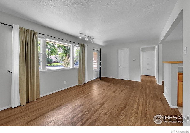 2416 15th Ave, Greeley, CO 80631 - unfurnished living room with a textured ceiling and wood finished floors