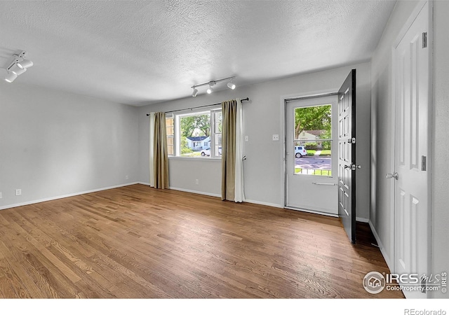 2416 15th Ave, Greeley, CO 80631 - foyer entrance with a textured ceiling, wood finished floors, and track lighting