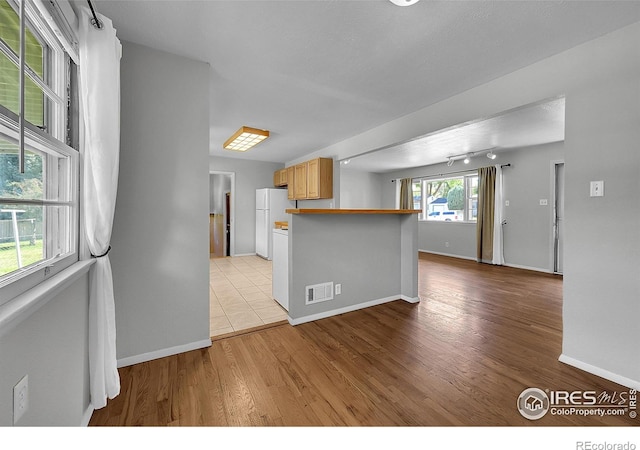 2416 15th Ave, Greeley, CO 80631 - kitchen featuring light wood finished floors and freestanding refrigerator