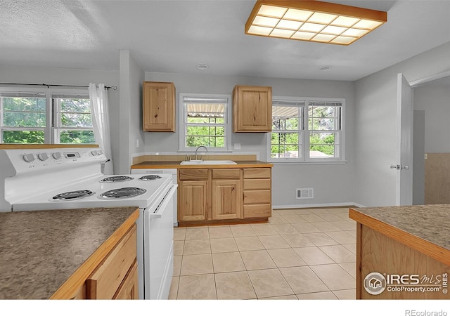 2416 15th Ave, Greeley, CO 80631 - kitchen with electric range and light tile patterned floors