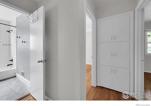 2416 15th Ave, Greeley, CO 80631 - bathroom featuring shower / tub combination and wood finished floors
