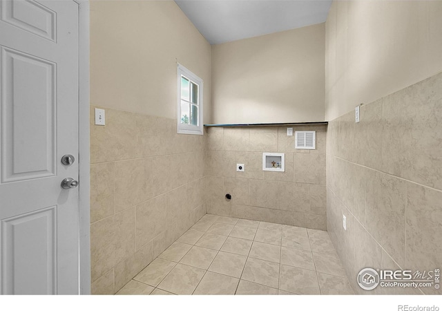 2416 15th Ave, Greeley, CO 80631 - laundry room with washer hookup, electric dryer hookup, tile walls, a wainscoted wall, and tile patterned flooring