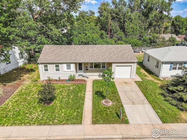 2416 15th Ave, Greeley, CO 80631 - view of front of home featuring an attached garage, driveway, a front lawn, and a shingled roof