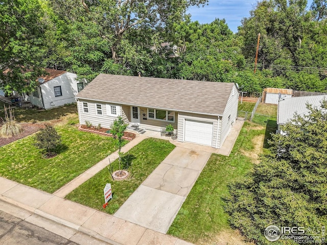 2416 15th Ave, Greeley, CO 80631 - view of front facade featuring a garage, a shingled roof, and driveway