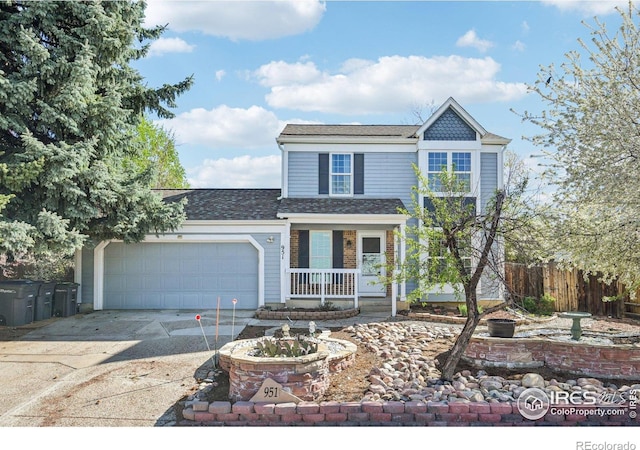 951 Vetch Cir, Lafayette, CO 80026 - traditional home with concrete driveway, covered porch, an attached garage, and roof with shingles
