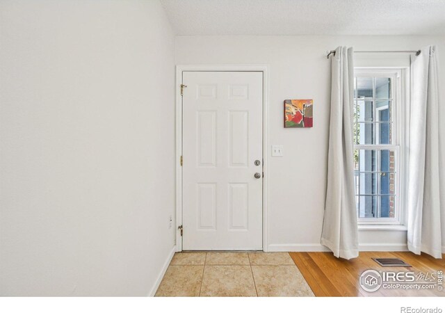 951 Vetch Cir, Lafayette, CO 80026 - foyer with baseboards and light tile patterned flooring