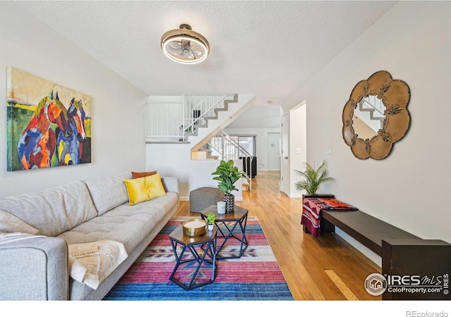 951 Vetch Cir, Lafayette, CO 80026 - living room featuring wood finished floors, stairs, and a textured ceiling