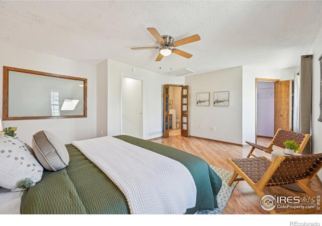951 Vetch Cir, Lafayette, CO 80026 - bedroom with wood finished floors, a textured ceiling, attic access, and ceiling fan