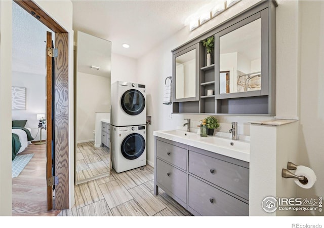 951 Vetch Cir, Lafayette, CO 80026 - laundry room featuring estacked washer and dryer and baseboards